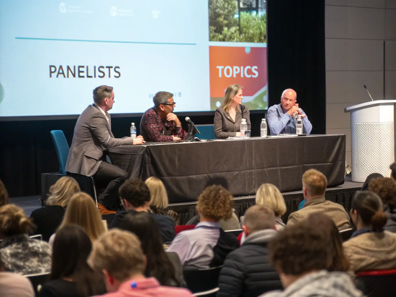 A professional image of a conference in Manchester, showcasing a panel discussion with industry experts. The setting should be modern and engaging, reflecting the conference's focus on innovation.